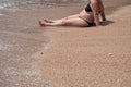 Mature overweight unattractive female body on a beach sand in a two